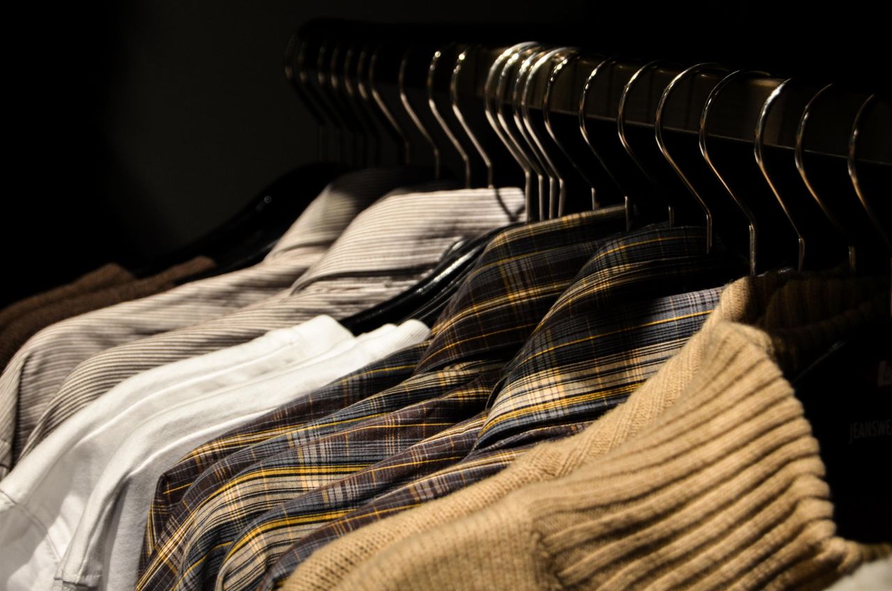 social-feed-img-03 Organized display of various shirts on hangers, showcasing fashion and style.