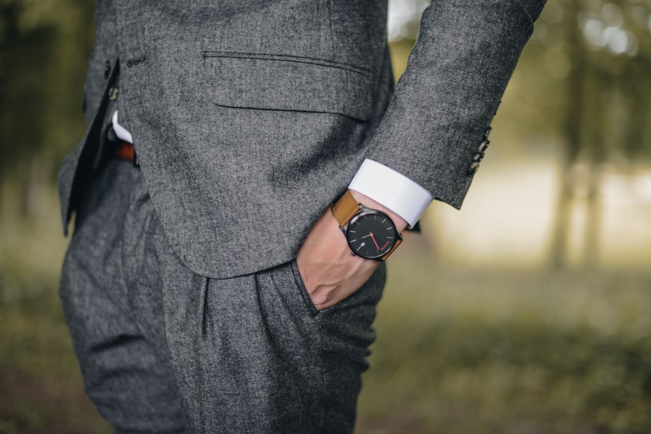 social-feed-img-02 Close-up of a man in a tailored suit wearing an elegant wristwatch outdoors, exuding fashion and sophistication.